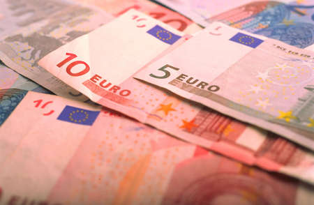 Monetary denominations of euro - advantage five and ten euros lay on  tableの写真素材