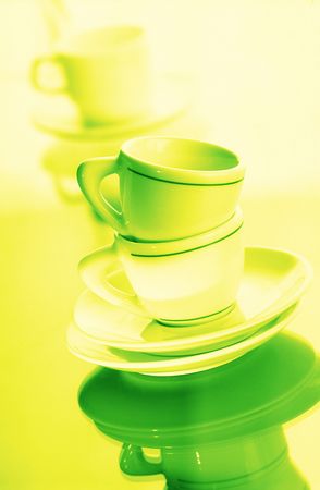washed pure utensils, coffee cups and plates on  green backgroundの写真素材