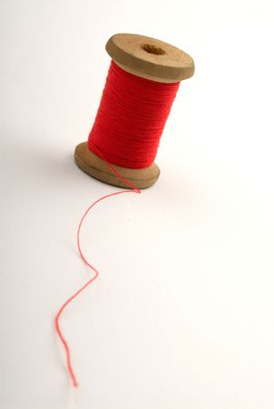 coil of red color of strings on white background, close up