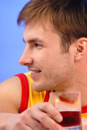 man's portrait, is dressed in bright clothes on  blue background