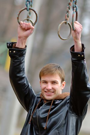 Young, nice guy trains on  sports equipment