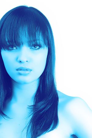 young woman looks in an objective,  portrait in dark-blue tonalitiesの写真素材