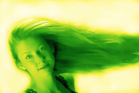 portrait of  young woman with  dismissed hair which looks in an objective on green backgroundの写真素材