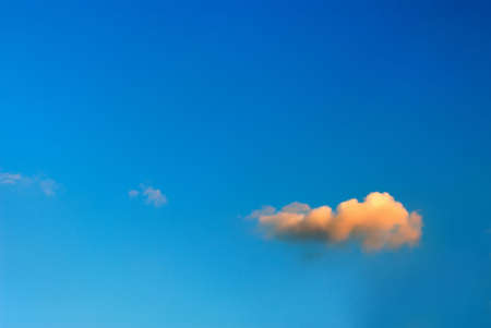 lonely orange cloud on  background of  dark blue skyの写真素材