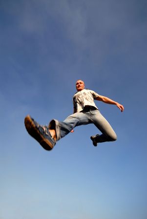 young guy in  jump on  background  dark blue sky