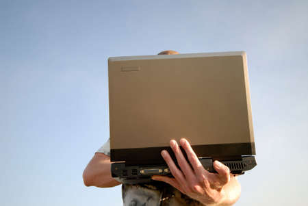 businessman on open air works on laptop