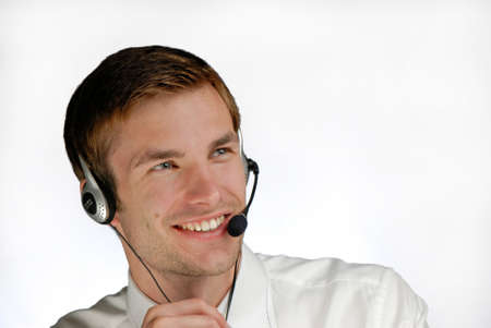 young  businessman works in headphones with  microphone on white background