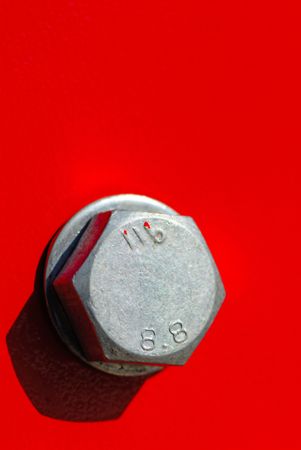 silvery color  bolt on  red background,  close upの写真素材