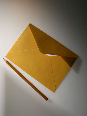 post envelope and pencil on  dark backgroundの写真素材