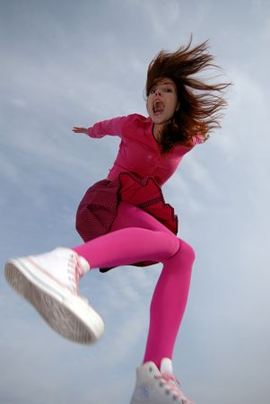 young girl dressed in pink colors to clothes in  jump on  background of  sky