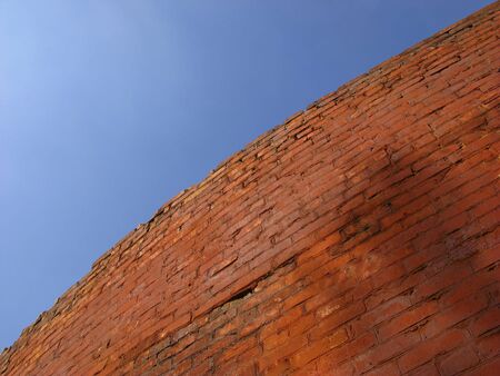 Old brick wall of red color on  background of  blue skyの写真素材