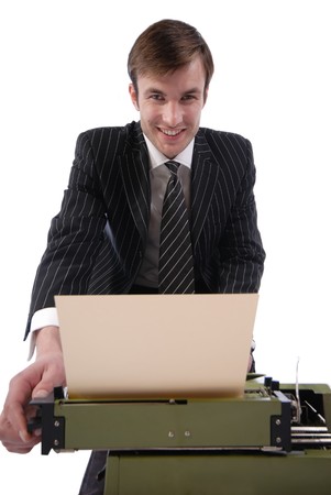 smiling businessman prints on old typewriterの写真素材