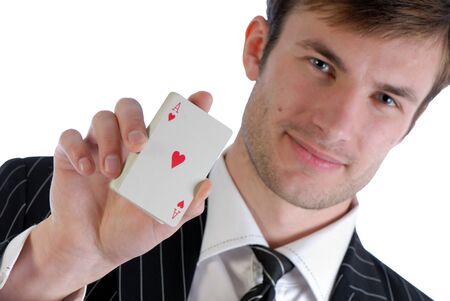 Young  man in  suit holds in  hand playing cards isolated on  white background
