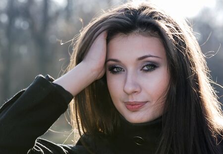 Portrait of  young smiling nice girl in  sunny day in parkの写真素材