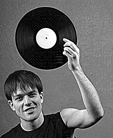 young man holds an old plate before  person