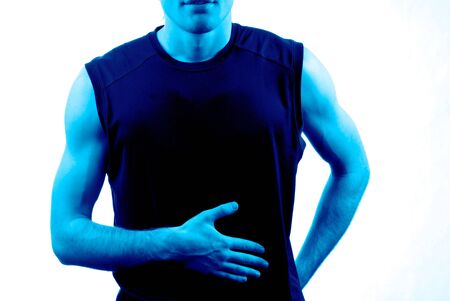 Body of  young guy of sports constitution on  light backgroundの写真素材