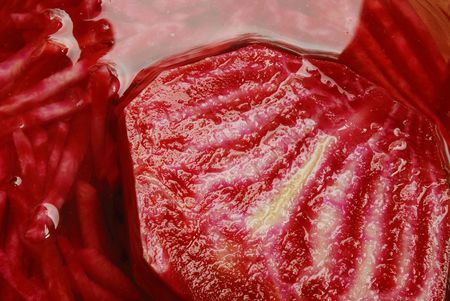 Slices of crude red beet are covered with water, a closeupの写真素材
