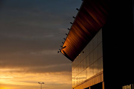 fragment of modern municipal building lighted up by light of a calling sunの写真素材