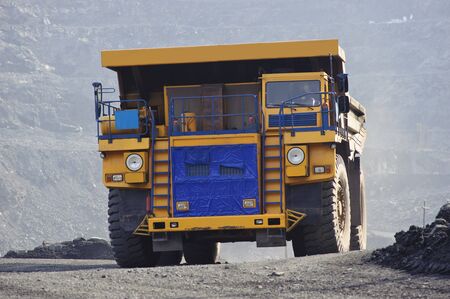 The big diesel lorry takes out iron ore from an open-cast mineの写真素材