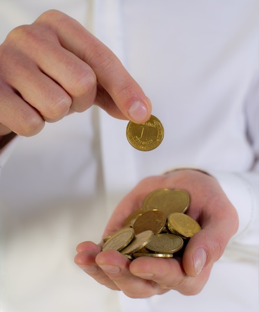 coins of one hryvnia in hands of the businessman