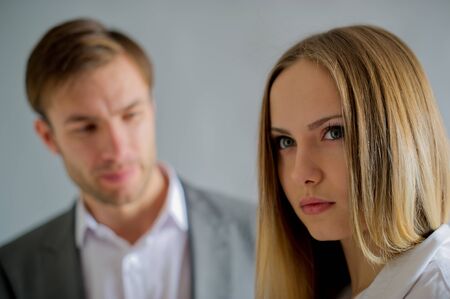 sad conversation of partners in business of the man and the woman at office