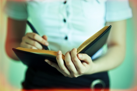 woman the secretary writes down information in a notebookの写真素材