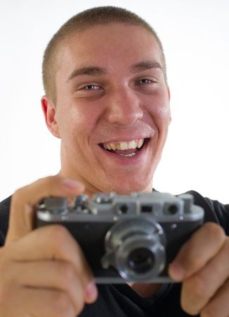 young photographer from old 35 mm the camera on a light backgroundの写真素材