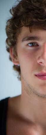 the nice young guy looks in the camera, a portrait, a closeupの写真素材