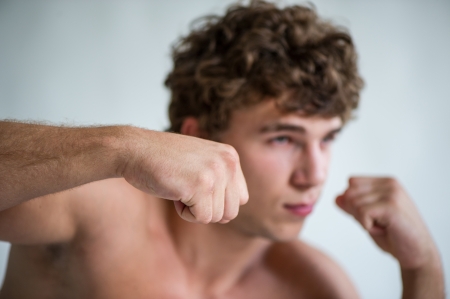 young man trains blow a hand, the washed-away backgroundの写真素材
