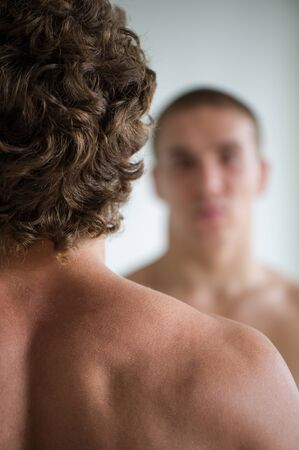 young nice man against other man on a light backgroundの写真素材