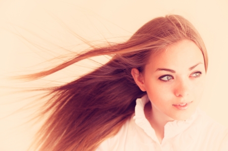 portrait of the beautiful, young, nice woman on a light backgroundの写真素材