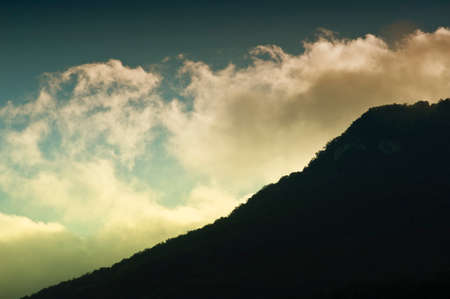 silhouettes of mountains covered with clouds, morningの写真素材