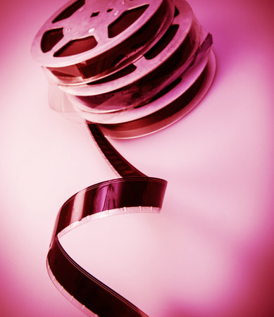 old reel of film of 16 mm on a pink の写真素材