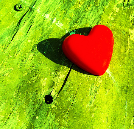 red heart on an old wooden surface, closeupの写真素材