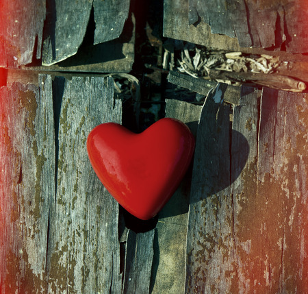 red heart on an old wooden surface, closeupの写真素材