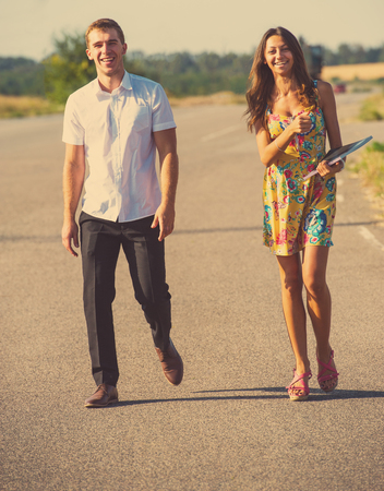 couple of young guys and girls walking on the roadの写真素材