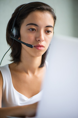Call center operator businesswoman with laptop computer, closeupの写真素材