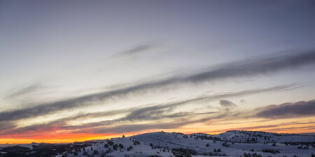 landscape in a mountainous area in the winter season, sunset, panoramaの写真素材