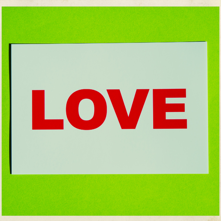 greeting card with text love on a green backgroundの写真素材