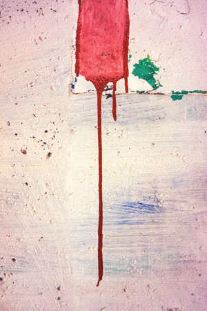 red ink spreads on the surface of stone painted wallの写真素材