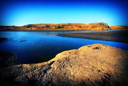 stones in a landscape river and sky in the countrysideの写真素材