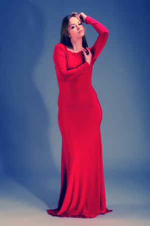 portrait of a pretty young blonde woman in evening dress in the studioの写真素材