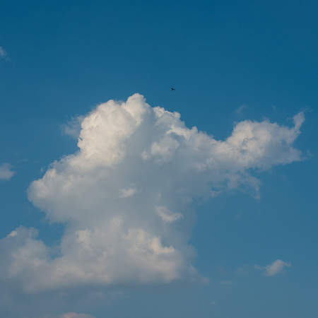white clouds against the blue sky on a sunny day