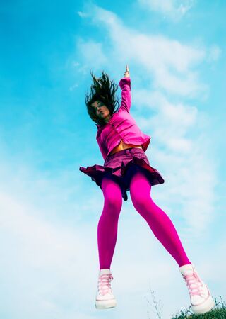girl jumped on the sky backgroundの写真素材