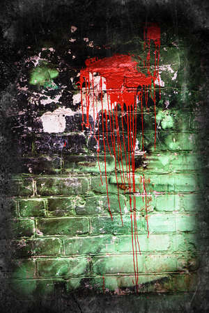 surface of old plaster crumbling spilled paint on a brick wallの写真素材