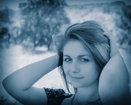 portrait of a pretty girl on the background of the gardenの写真素材