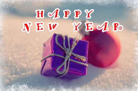 New Year's toys on snow and text happy new year