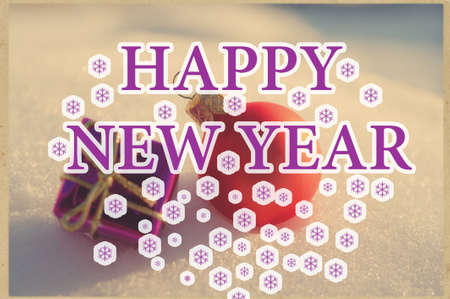 New Year's toys on snow and text happy new year