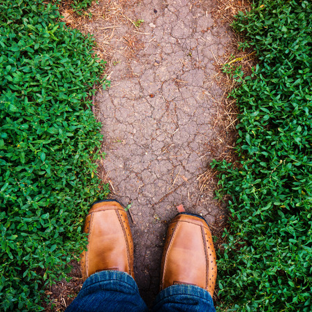 Men's shoes and a walking trail in the urban environmentの写真素材