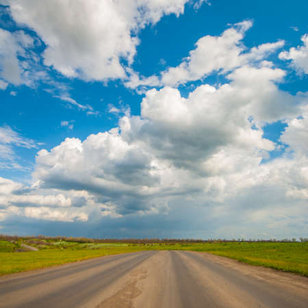 Old asphalt road in the countryside, spring landscapeの写真素材
